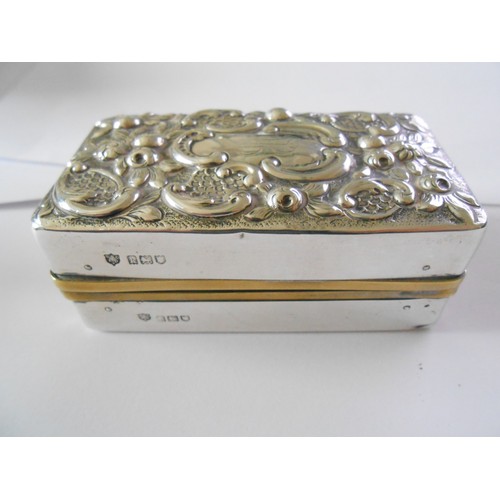 194 - Four glass toilet bottles with repousse decorated silver lids and a matching rectangular silver cove... 