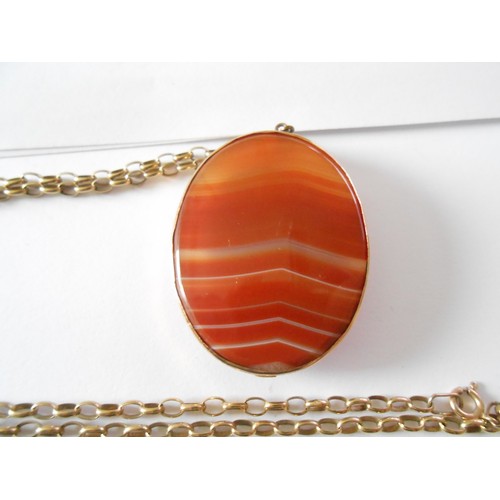 231 - An agate pendant depicting head and shoulders of a lady in a 9ct. gold frame, on a 9k. gold chain