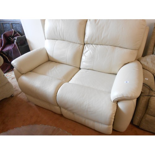 83 - A modern cream leather reclining two seater settee and matching three seater reclining settee