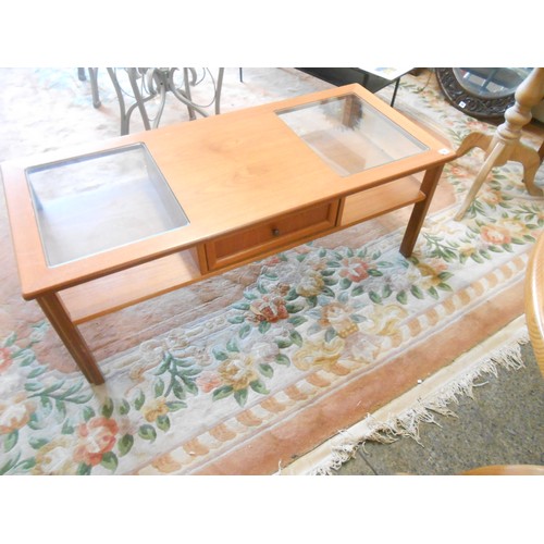 88 - A 1970/80's teak two tier coffee table with glass top and fitted centre drawers - 48in. wide