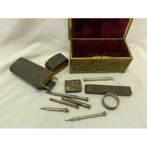 303 - A bronze casket with raised decoration to the lid of a huntsman and dogs, the border decorated with ... 