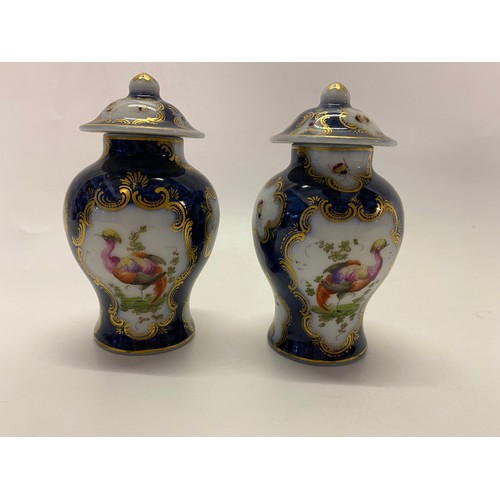 153 - A pair of Samson small baluster form vases and covers in the Chinese taste, deep blue ground painted... 