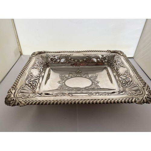 241 - A rectangular silver dish with gadroon border, shell pattern corners, saw pierced floral and leaf sc... 