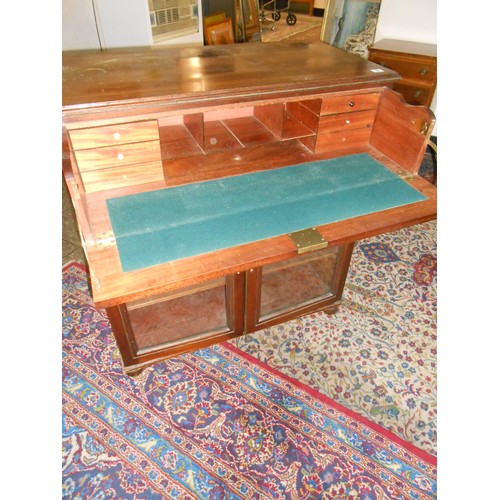 49 - A 19th Century side cabinet fitted secretaire drawer with brass knob handles above two glass doors, ... 