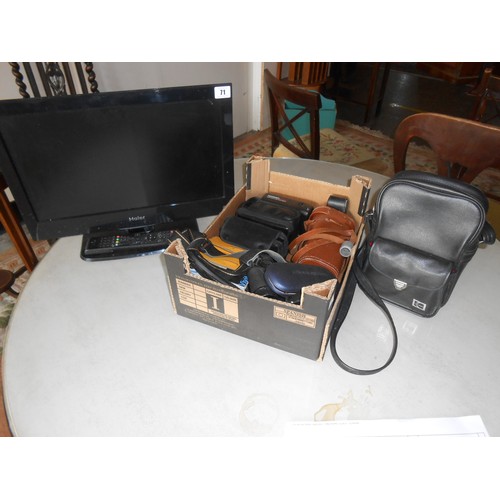 71 - A Haier flatscreen television, a pair of binoculars and various cameras