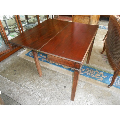 91 - A Georgian mahogany tea table with rectangular folding top, on square legs - 34in. wide