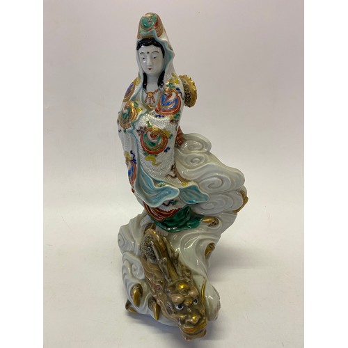 185 - A Japanese model of Quan Yin riding a wave with a dragon at her feet - 14in. high