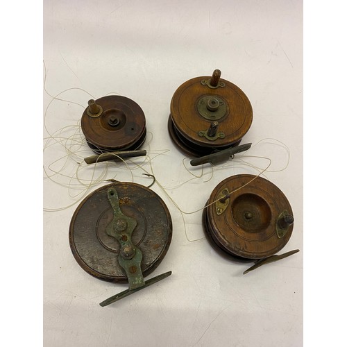 297 - Four vintage wooden fishing reels