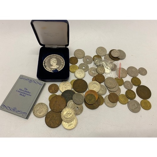 299 - A small quantity of silver six pences, a silver three pence coin, a sterling silver Queen Elizabeth ... 