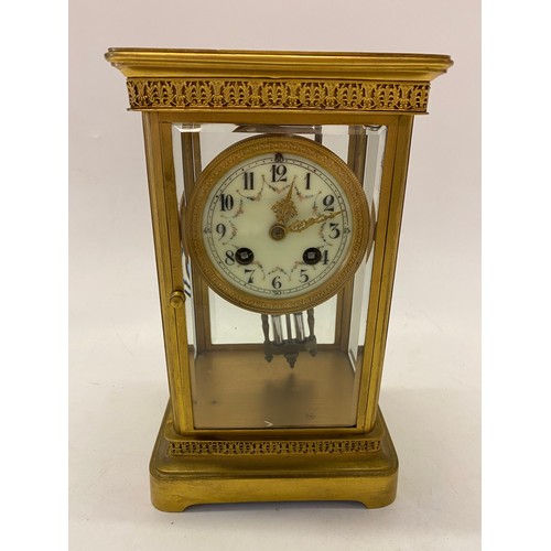 303 - A mantel clock with cream enamel dial decorated floral swags, mercury pendulum, in a four glass and ... 