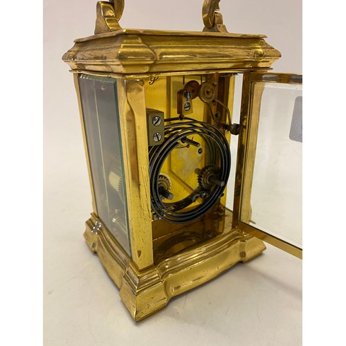 320 - A Victorian carriage clock, white enamel dial, French striking movement on a gong, in a brass and be... 