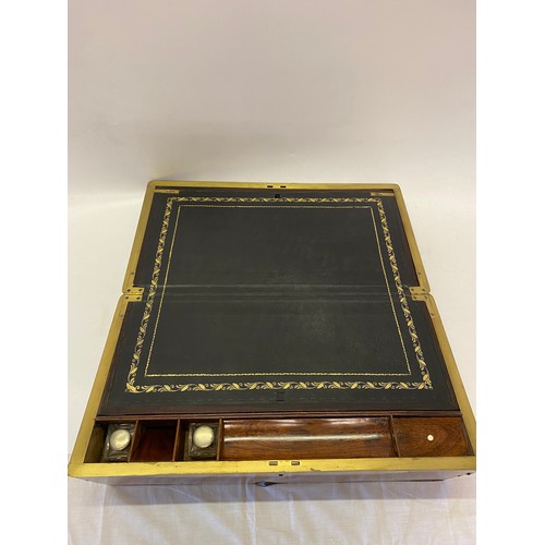 323 - A 19th Century amboyna and brass banded writing box with fitted interior - 20 1/2in. wide