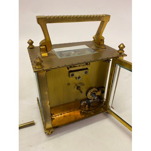 332 - A carriage clock, white enamel dial, in a brass and glass case, complete with leather travelling cas... 