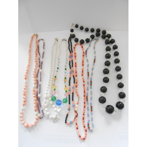 202 - A quantity of bead necklaces with 9ct. gold clasps