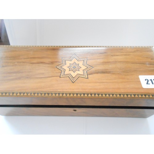 213 - A walnut and inlaid glove box containing a selection of costume jewellery including paste set buckle... 