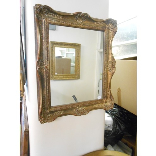 79 - A rectangular wall mirror in a gilt frame with moulded decoration - 29in. x 25in. and one other rect... 