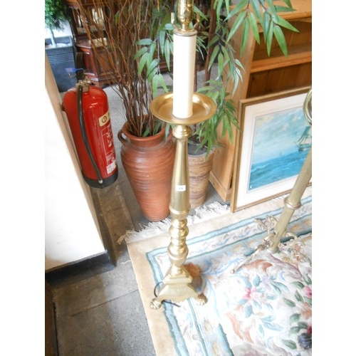 84 - A brass floor standing lamp in the form of a pricket candlestick on trefoil base with three leaf for... 