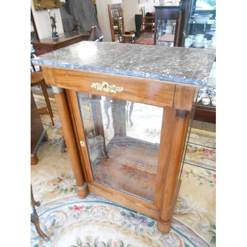 95 - A Continental walnut cabinet with grey marble top, fitted bevelled glass door and sides, turned colu... 