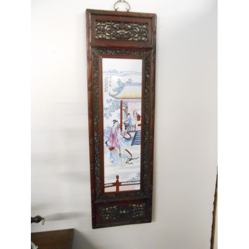 100 - A pair of modern Chinese panels in pierced and carved wood frames - 47 1/2in. x 14in.