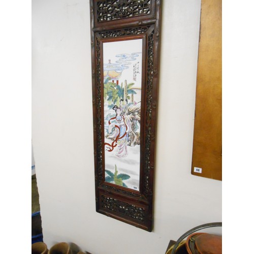 100 - A pair of modern Chinese panels in pierced and carved wood frames - 47 1/2in. x 14in.