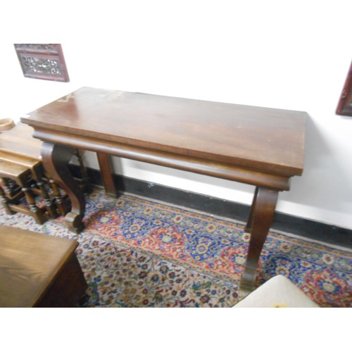 102 - A mahogany console table with rectangular top, on scroll forelegs - 50in. wide