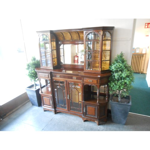 115 - An Edwardian Gillows display cabinet, the upper part fitted centre mirror with gold velvet decoratio... 