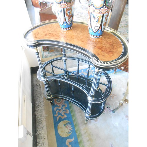 127 - A Victorian amboyna and ebonised music Canterbury of kidney form, with fluted supports, on turned le... 