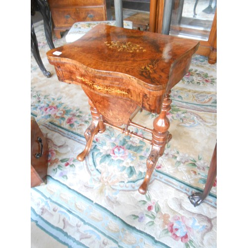 138 - A Victorian walnut and satinwood inlaid games/sewing table with shaped hinged lid enclosing chess an... 