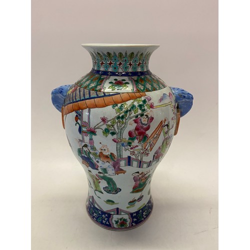 166 - A Chinese vase decorated all round with figures in garden scenes, blue elephant form ring handles, d... 