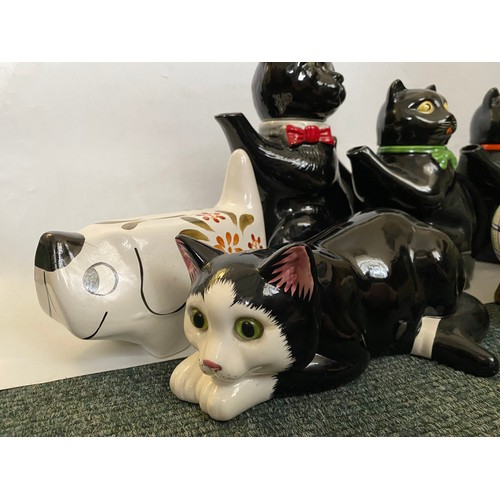 99 - Four Arthur Wood black glazed cat form teapots, a grey ditto, two Arthur Wood money boxes in the for... 