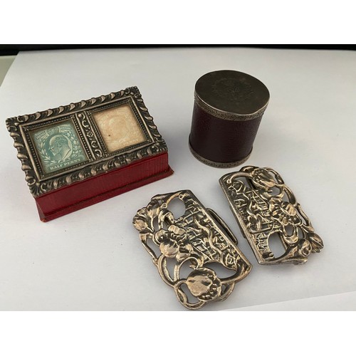 191 - A silver buckle decorated poppies and lizard - Birmingham 1983, a silver coloured metal vesta case a... 