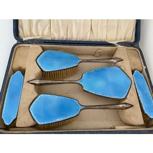 183 - A lady's five piece silver and blue enamel backed dressing table set in fitted box - Birmingham 1929... 