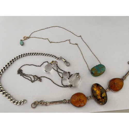 205 - A silver coloured metal bracelet set three amber panels, a scarab pendant on a silver chain with 9ct... 