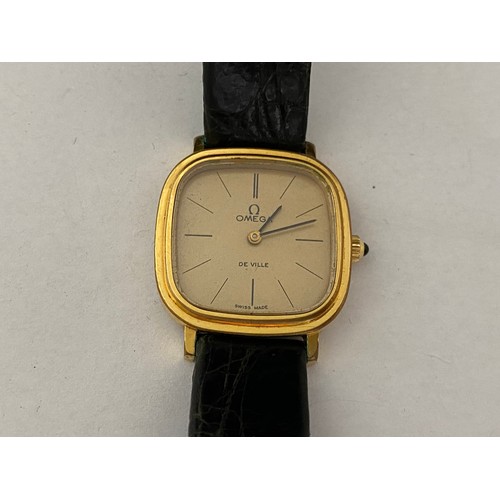 204 - A lady's Omega Deville quartz wristwatch in a gold plated case, on black leather strap