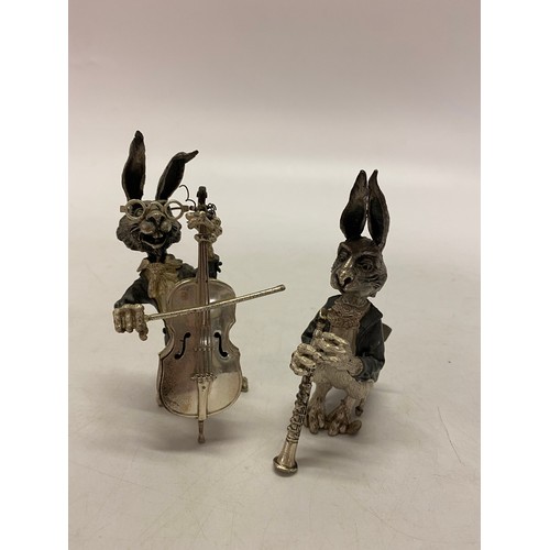 181 - Two white metal models of a hare playing a clarinet and a hare playing a cello