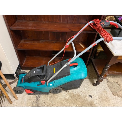 42 - A Bosch electric lawn mower and a quantity of garden hand tools