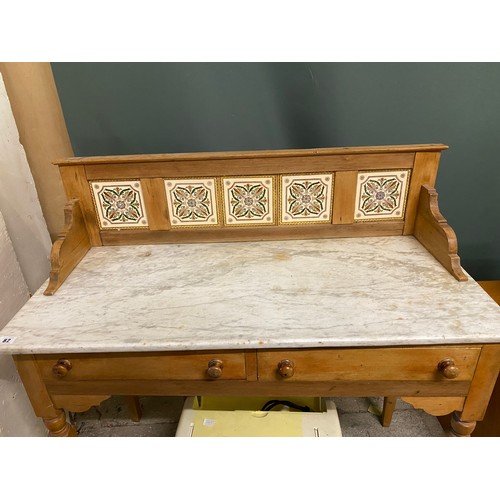 82 - A Victorian pine washstand with marble top, tile back, two frieze drawers, on square tapered and tur... 