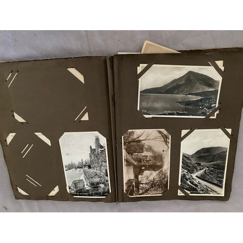 10 - A postcard album containing early 20th Century black and white and coloured postcards