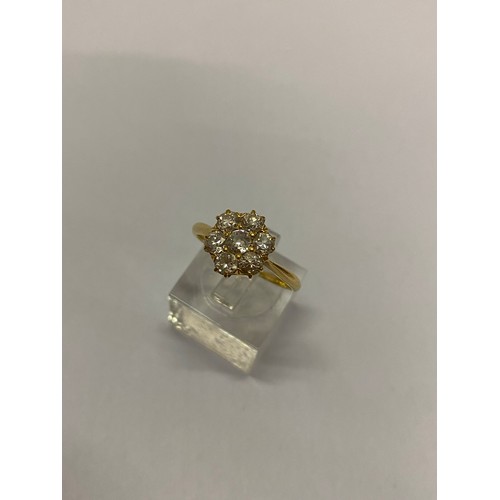 273 - A lady's daisy cluster ring set diamonds, on a gold shank