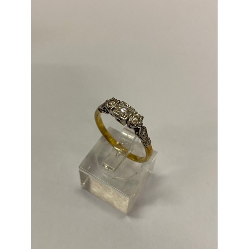 274 - A lady's three stone diamond ring on an 18ct. gold shank