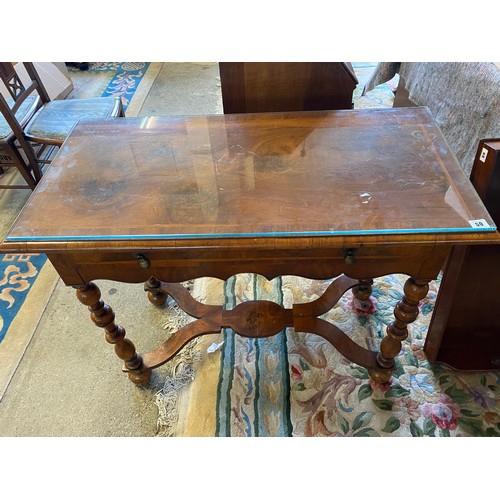 50 - A Continental walnut side table with rectangular top, frieze drawer, shaped apron, on baluster turne... 