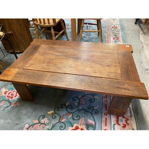 40 - An oak coffee table with rectangular top, on square legs - 44in. x 28in.