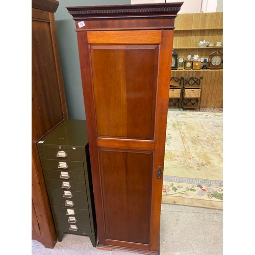 25 - A mahogany single door wardrobe with canted cornice, panelled door, on platform base - 19in. wide