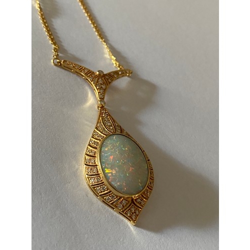 306 - A Continental gold pendant set large centre opal surrounded by diamonds on a gold chain marked 800