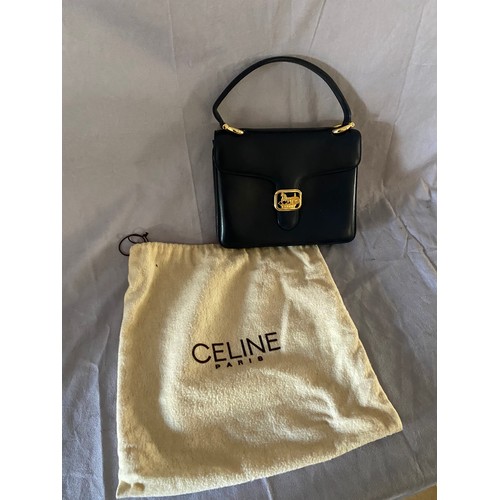 142 - A Celine blue calf leather handbag with top handle, the flap with a yellow hardware flip clasp, the ... 