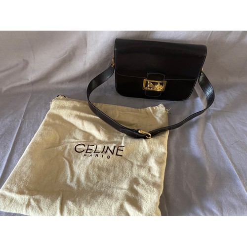 141 - A Celine vintage brown calf leather box bag with gilt horse and carriage buckle, the interior with t... 