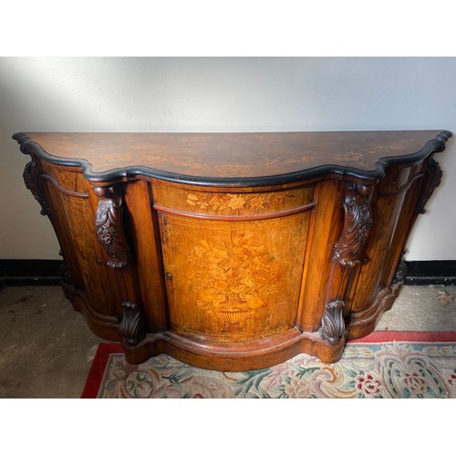 23 - A Victorian walnut and satinwood floral inlaid credenza with serpentine shaped front, carved scroll ... 