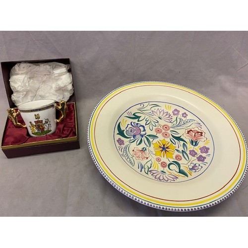 114 - A Poole Pottery charger painted flowers - 15in. dia. and a Paragon commemorative loving cup in fitte... 