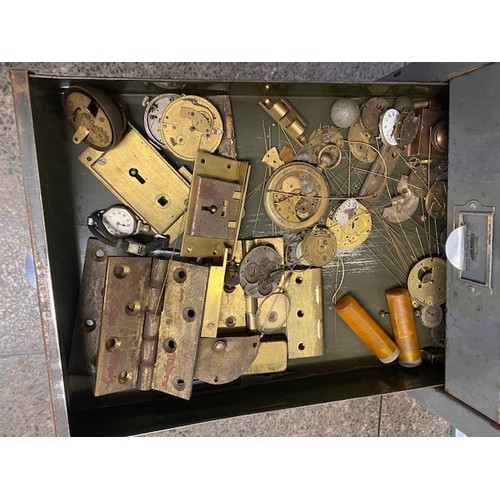 97 - A grey metal filing chest containing clock dials, Georgian and later hands, pocket watch glasses, to... 