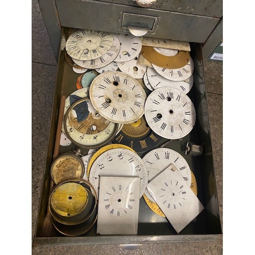 97 - A grey metal filing chest containing clock dials, Georgian and later hands, pocket watch glasses, to... 